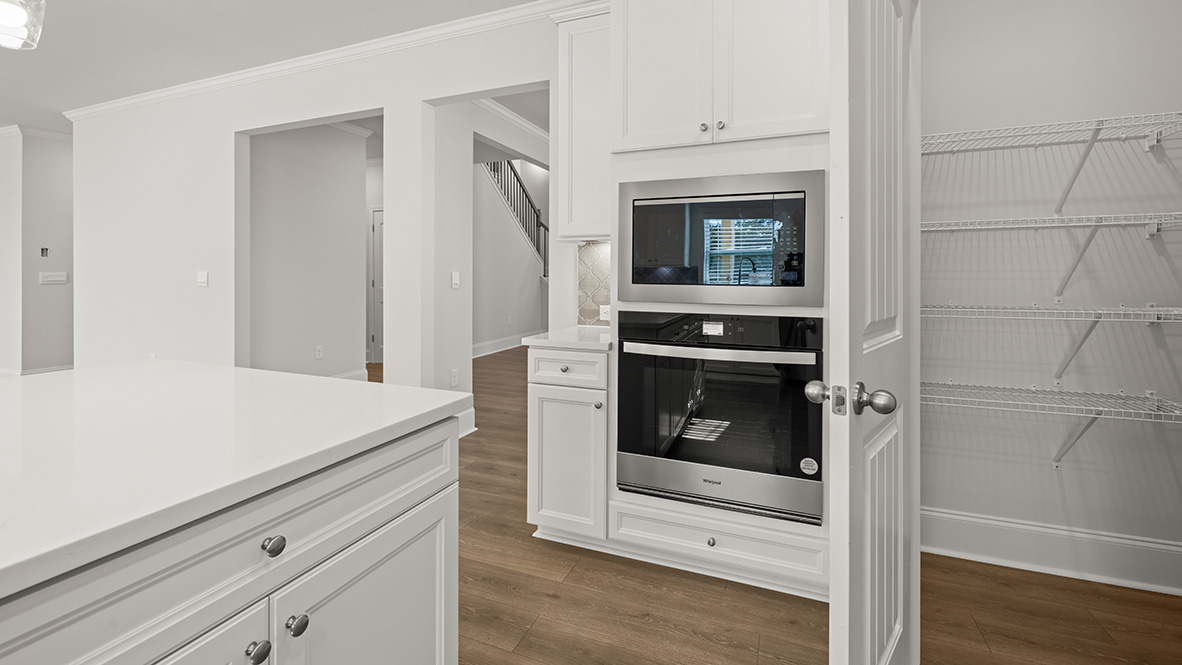 Interior kitchen with center island and white cabinets