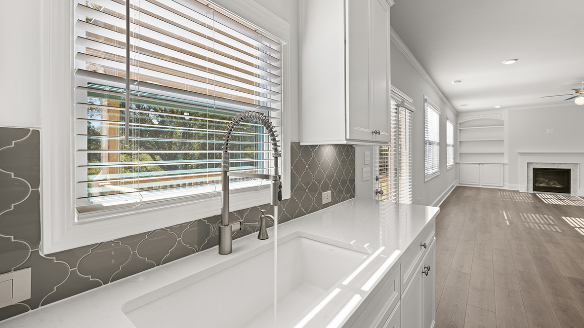 Interior kitchen with center island and white cabinets