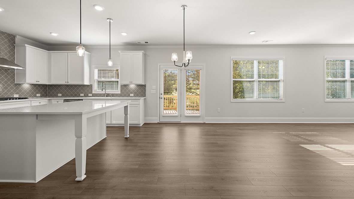 Interior kitchen with center island and white cabinets