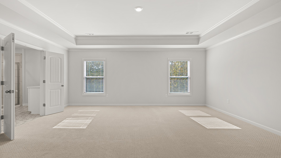 Interior primary bedroom with windows