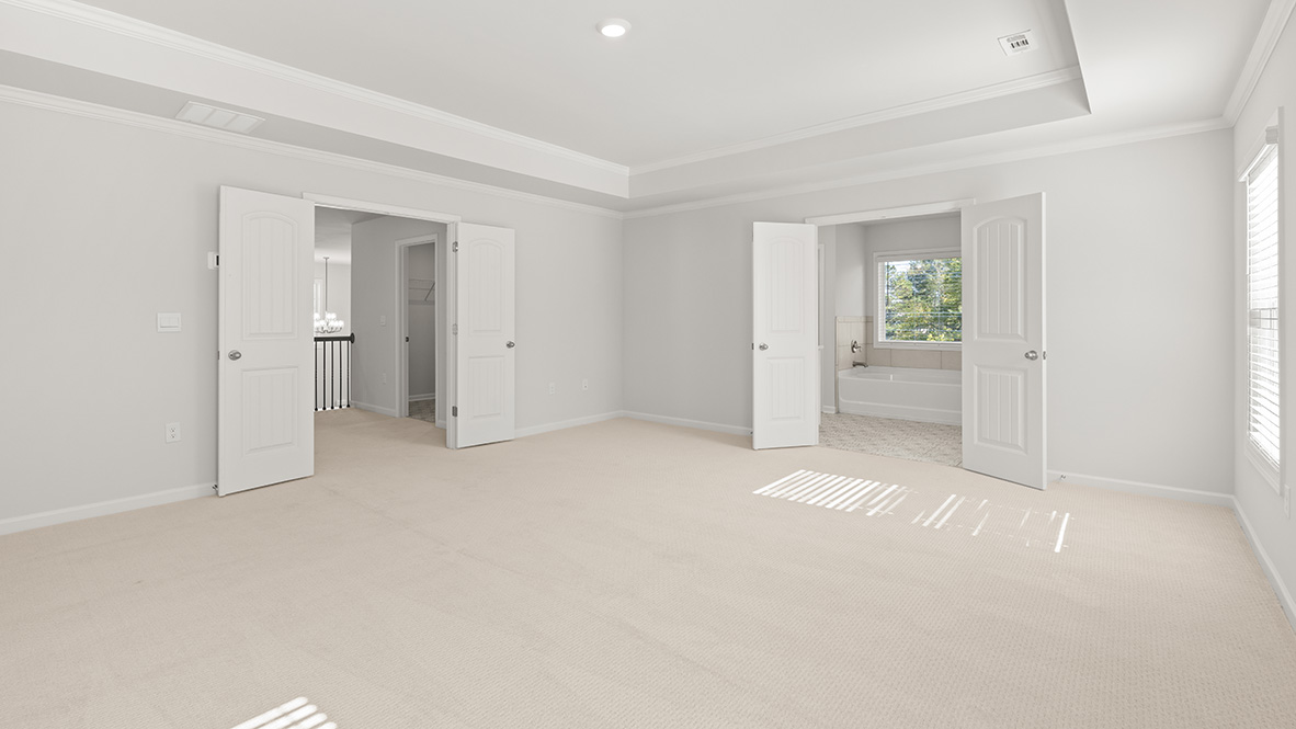 Interior primary bedroom with windows