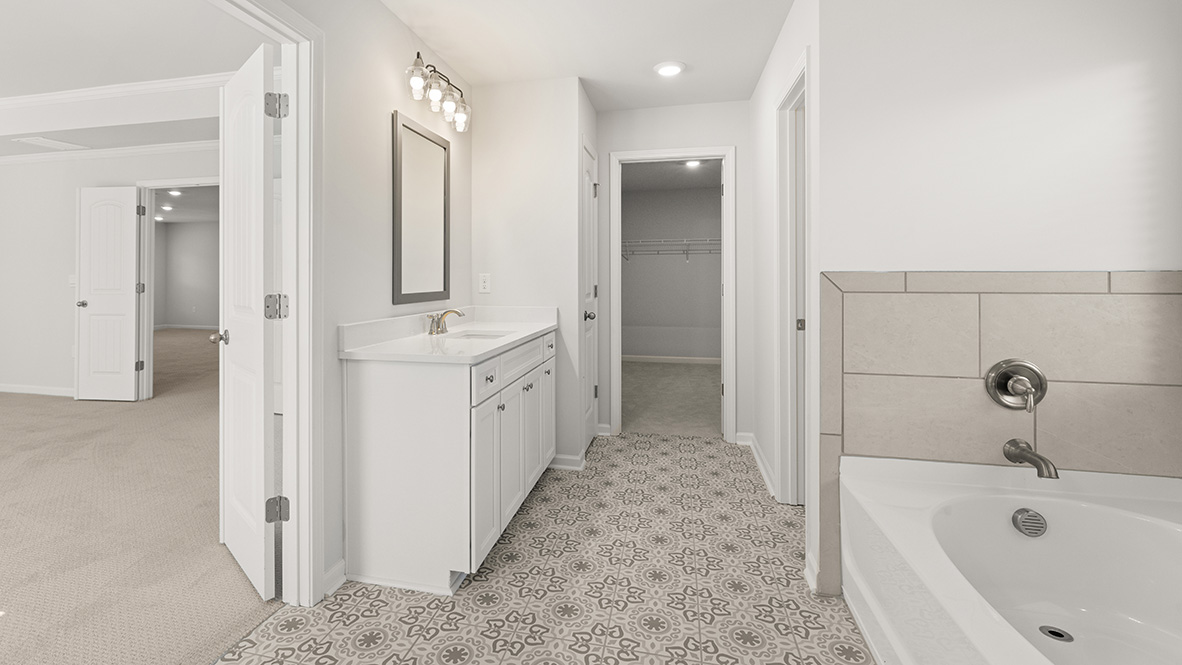 Interior primary bathroom with bath tub and shower