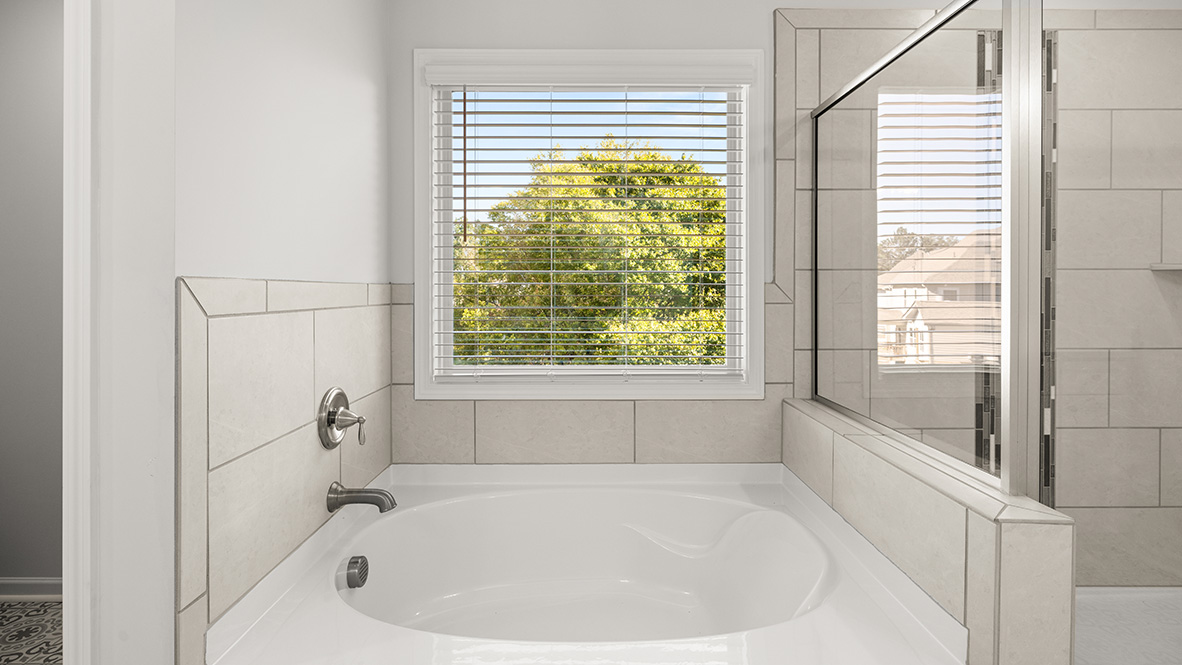 Interior primary bathroom with bath tub