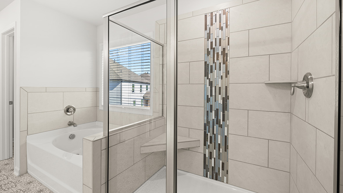 Interior primary bathroom with bath tub and shower