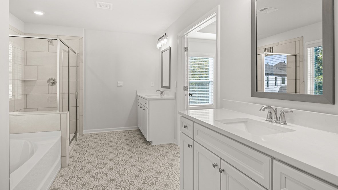 Interior primary bathroom with bath tub, shower and double sink