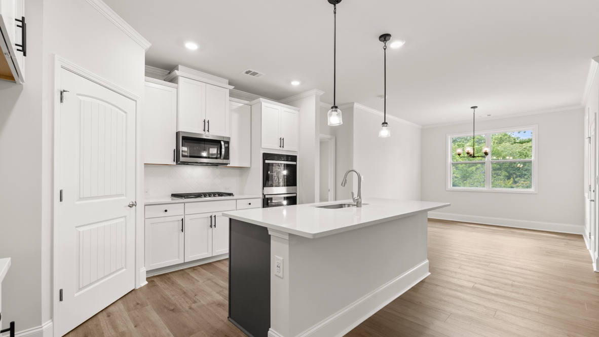 Interior kitchen with center island and white cabinets