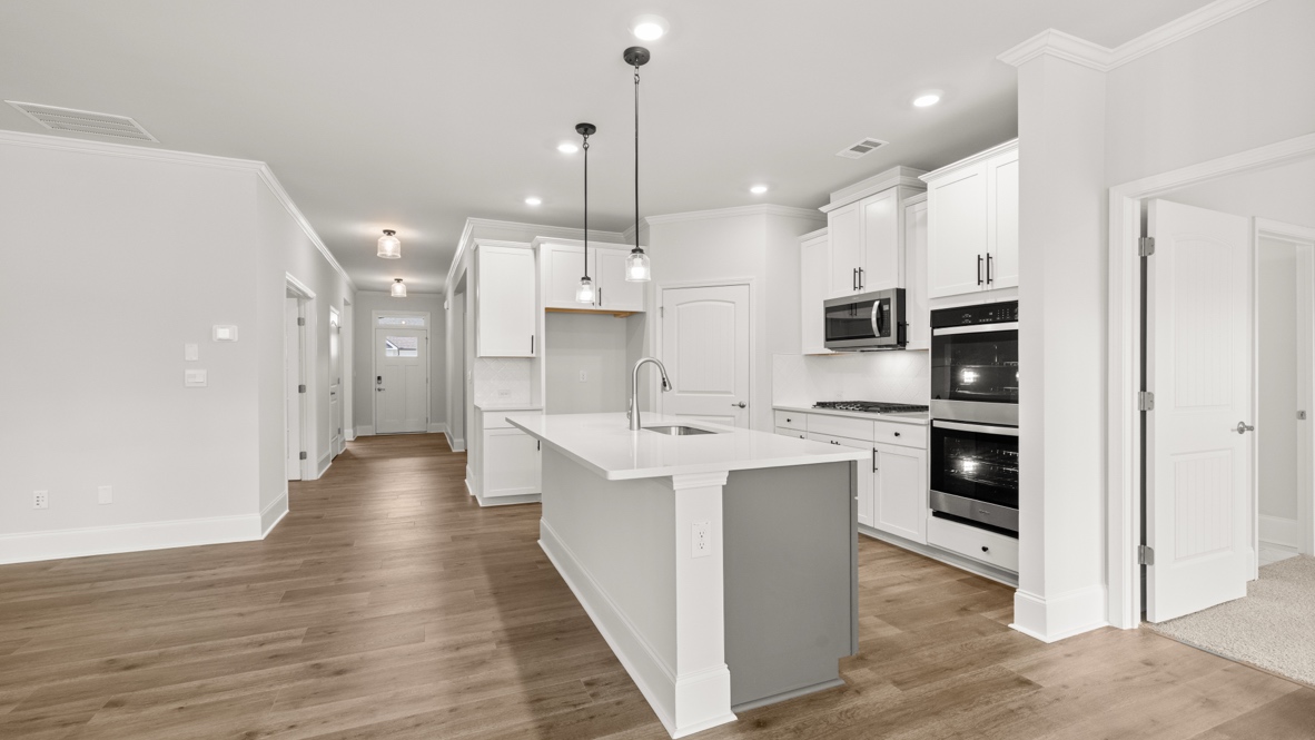 Interior kitchen with center island and white cabinets