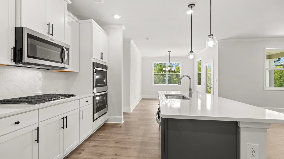 Interior kitchen with center island and white cabinets