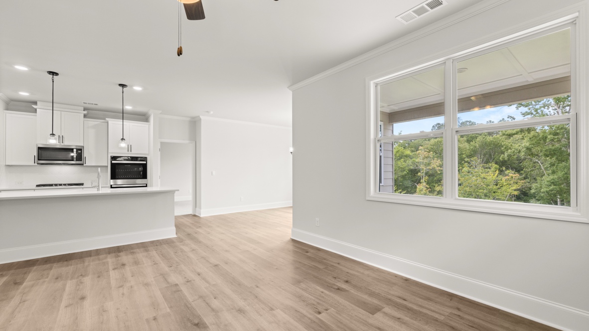 Interior living area with large window and open to kitchen