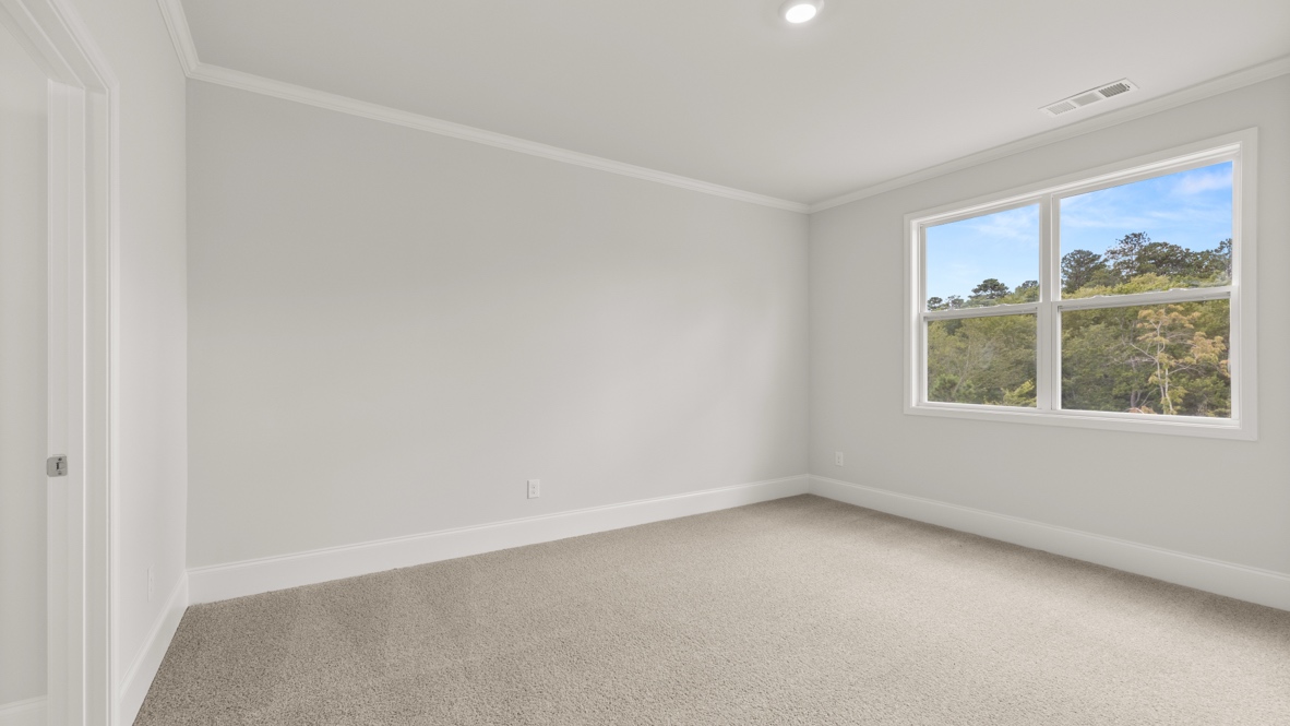 Interior primary bedroom with large window