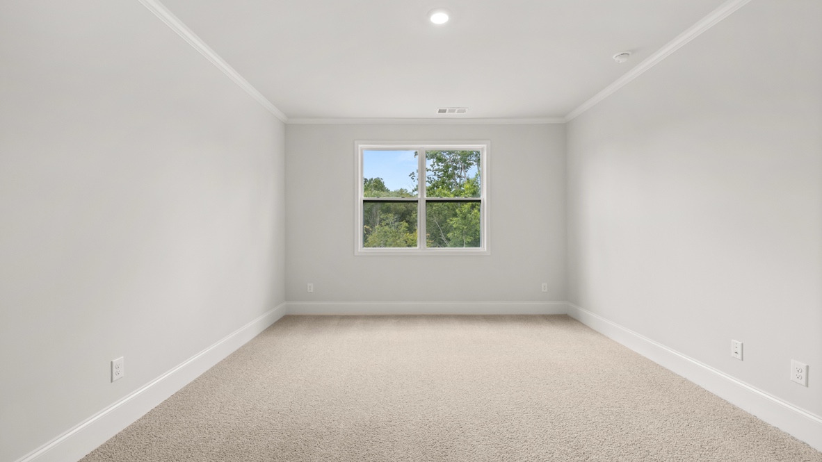 Interior primary bedroom with large window