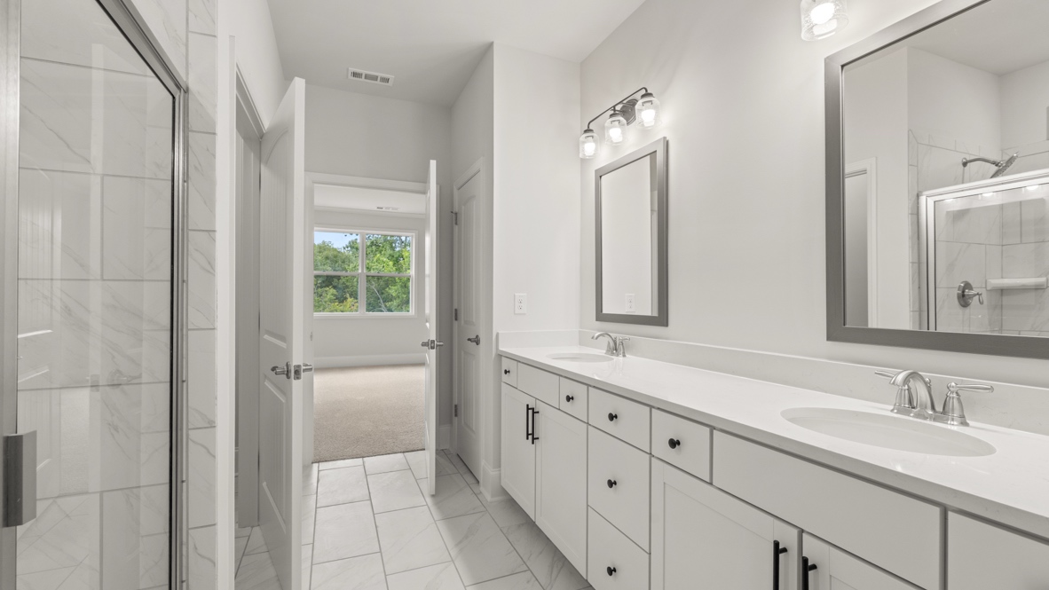 Interior primary bathroom with double sink and shower