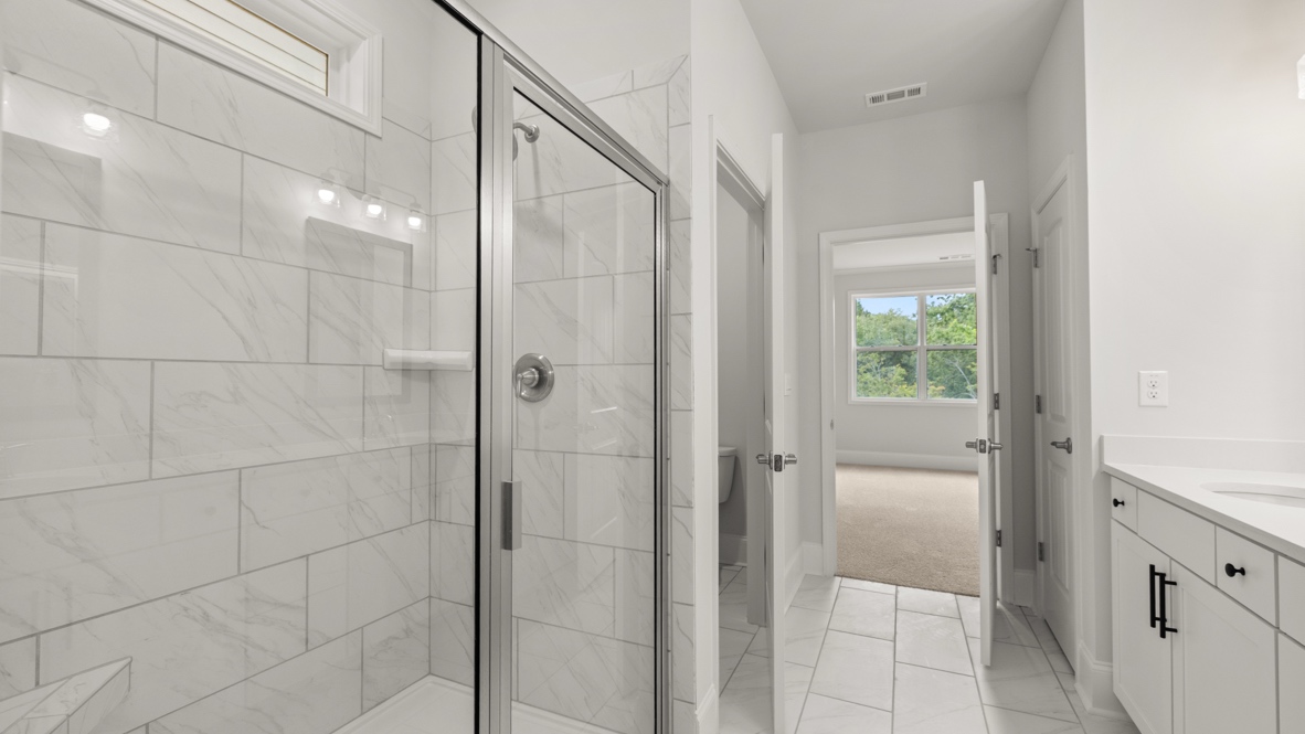 Interior primary bathroom with double sink and shower