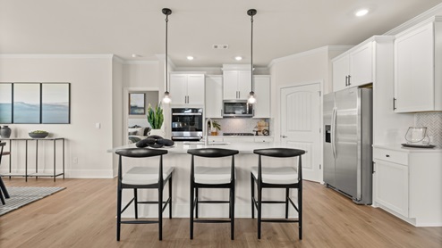 kitchen with white cabinetry, large island and stainless steel appliances