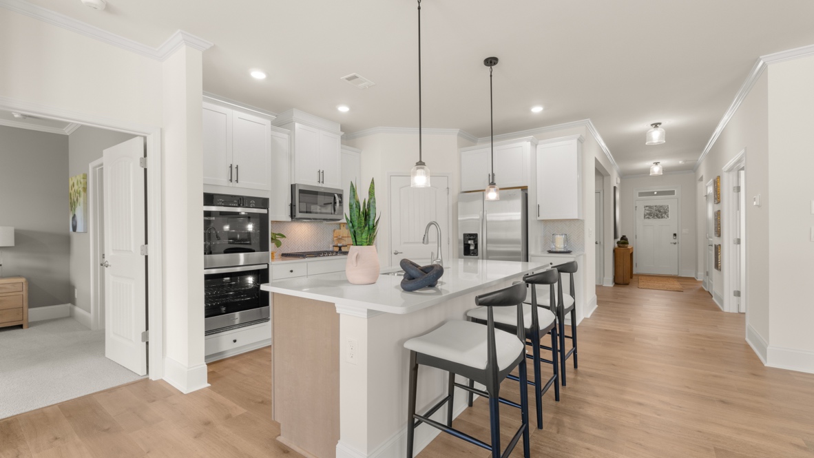 kitchen with white cabinetry, large island and stainless steel appliances