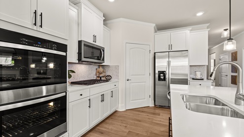 kitchen with white cabinetry, large island and stainless steel appliances