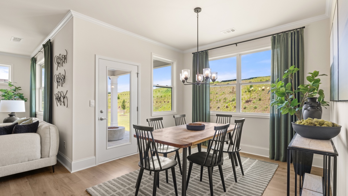 dining room next to the kitchen with a table with 6 black chairs