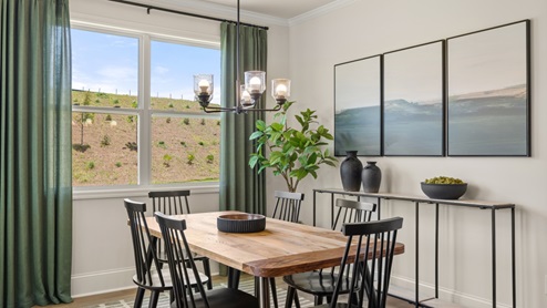 dining room next to the kitchen with a table with 6 black chairs