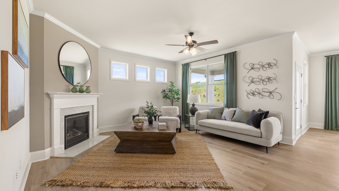 cozy living room with a grey sofa, two accent chairs and green curtains