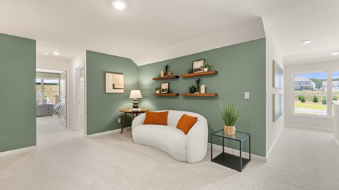 flex room with a white sofa and floating bookshelves above