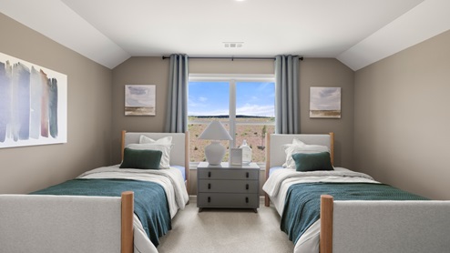 bedroom with two twin beds with a large window in the middle
