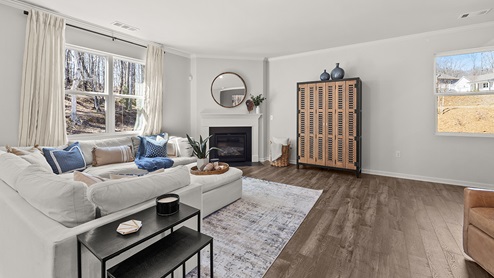 large open concept living room with a corner fireplace