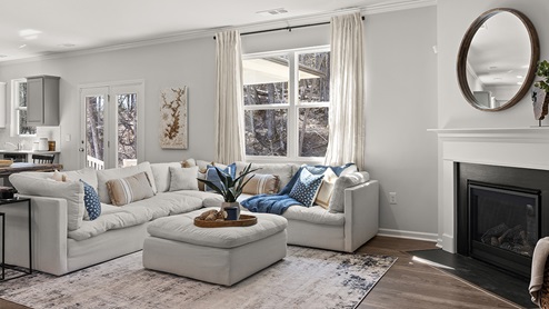 large open concept living room with a corner fireplace