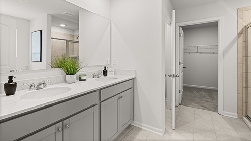 large upgraded primary bathroom with dual vanity