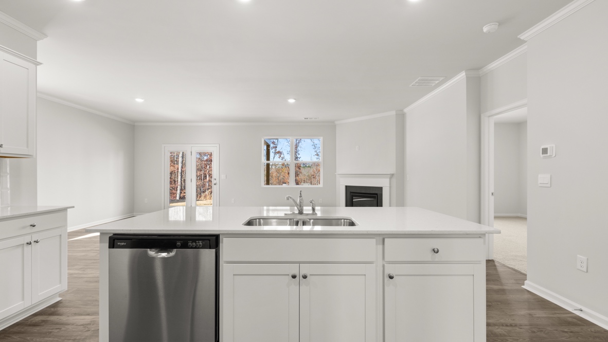Interior kitchen with center island and white cabinets