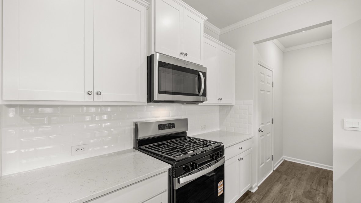 Interior kitchen with center island and white cabinets