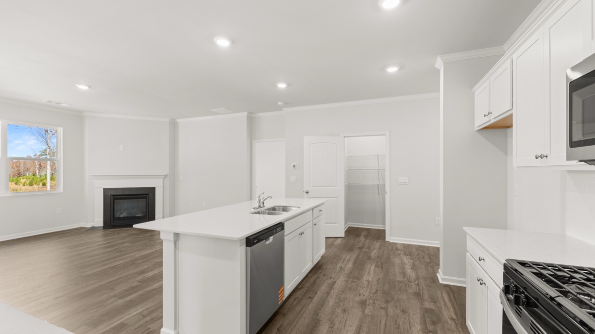 Interior kitchen with center island and white cabinets