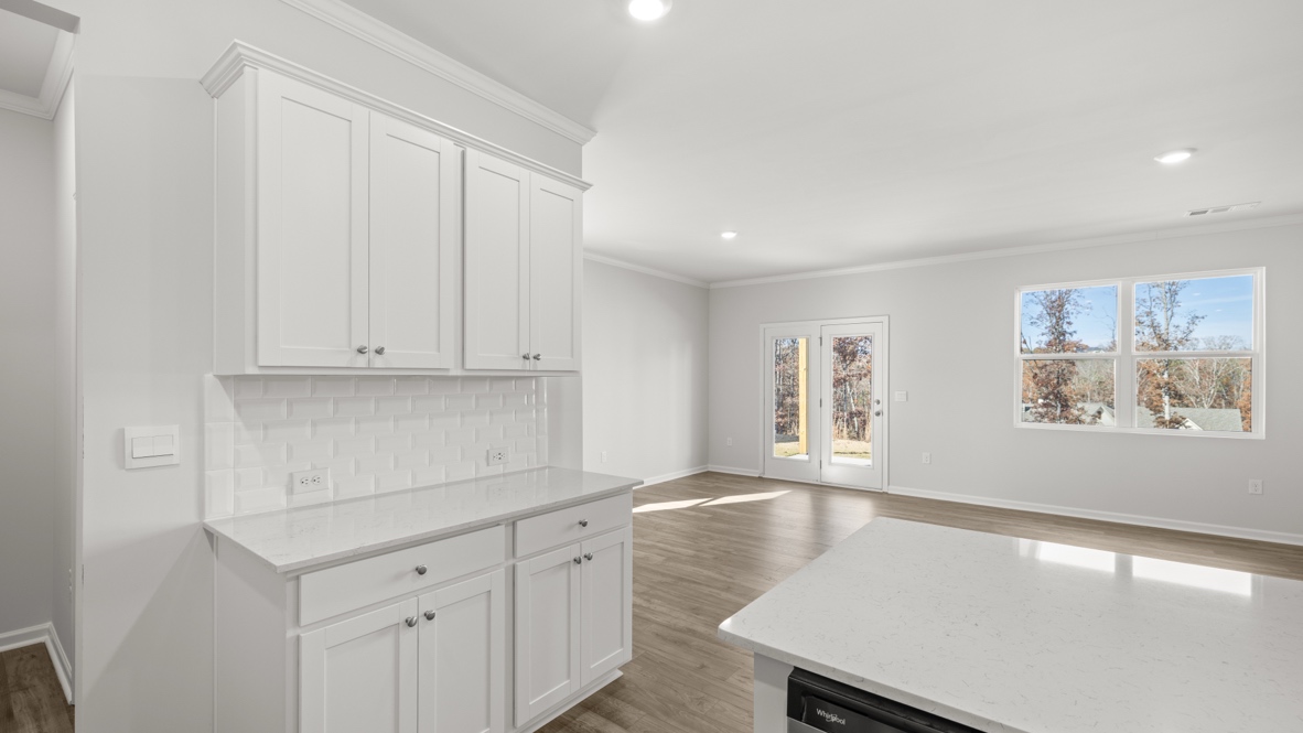 Interior kitchen with center island and white cabinets