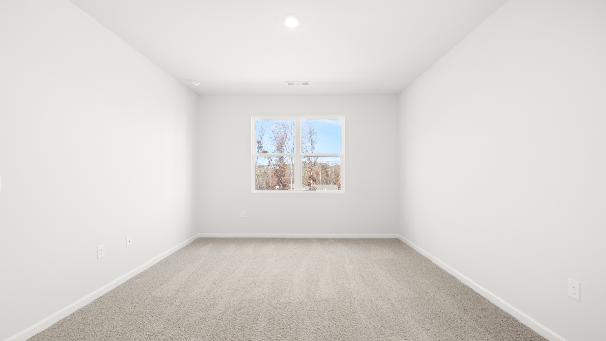 Interior primary bedroom with large windows