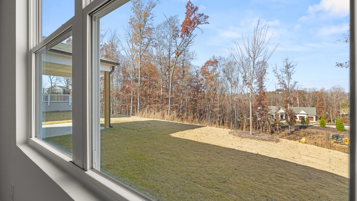 Interior primary bedroom with large windows