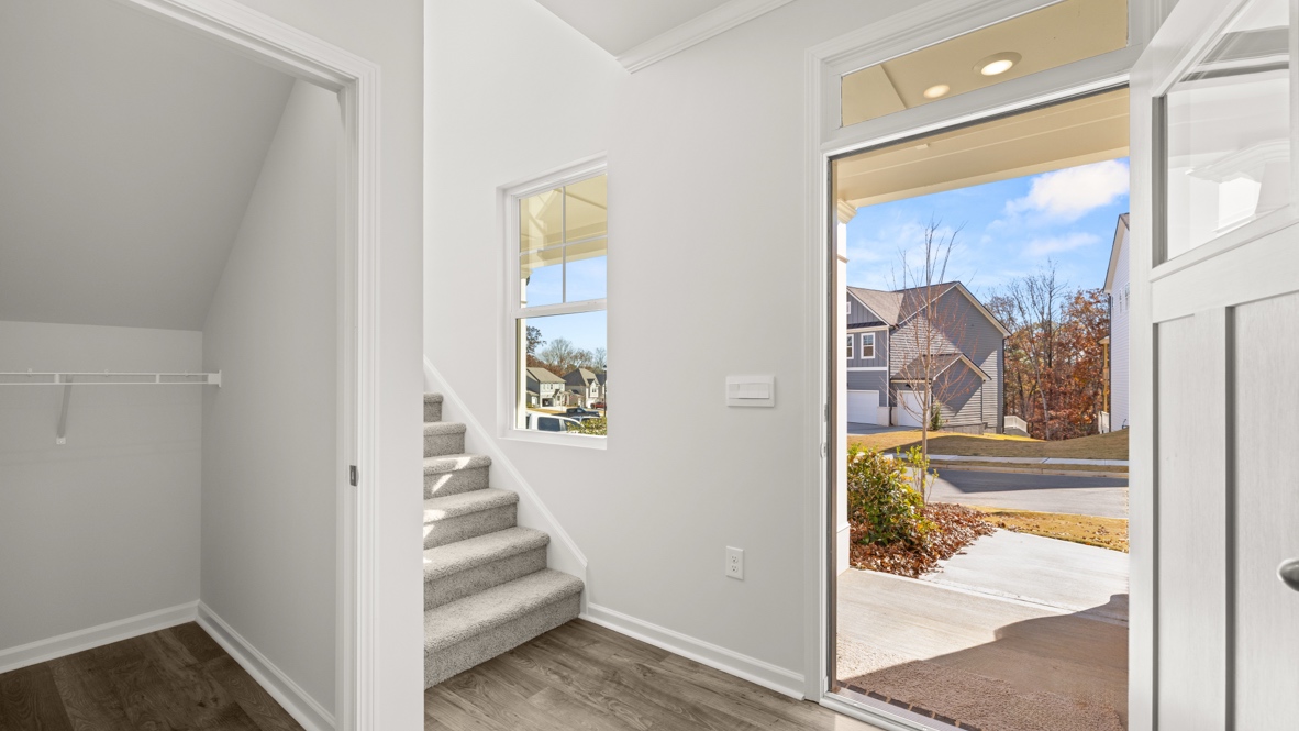 Interior entry-way open to staircase and hall closet