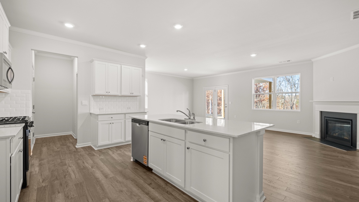 Interior kitchen with center island and white cabinets