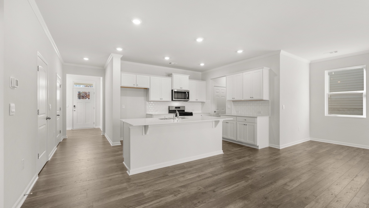 Interior kitchen with center island and white cabinets
