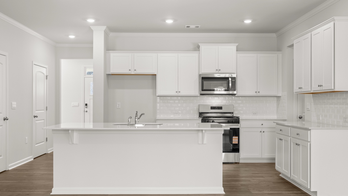 Interior kitchen with center island and white cabinets