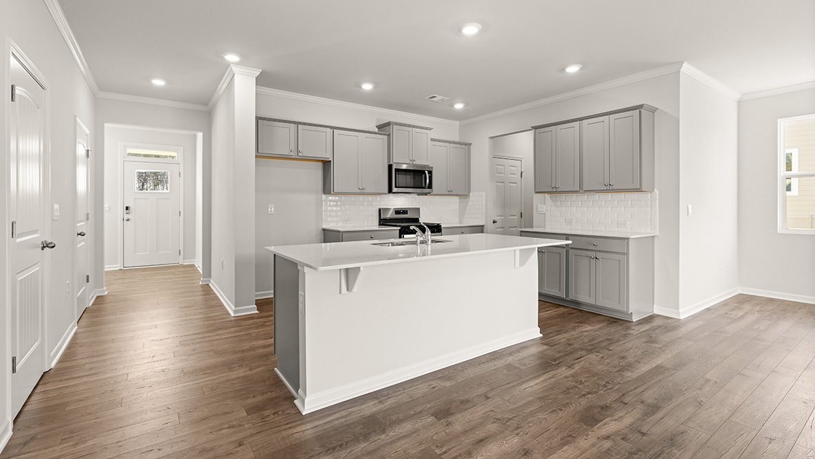 Interior kitchen with center island and light grey cabinets