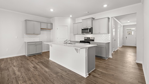 Interior kitchen with center island and light grey cabinets