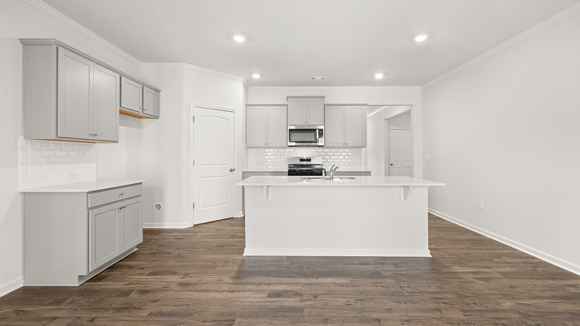 Interior kitchen with center island and light grey cabinets
