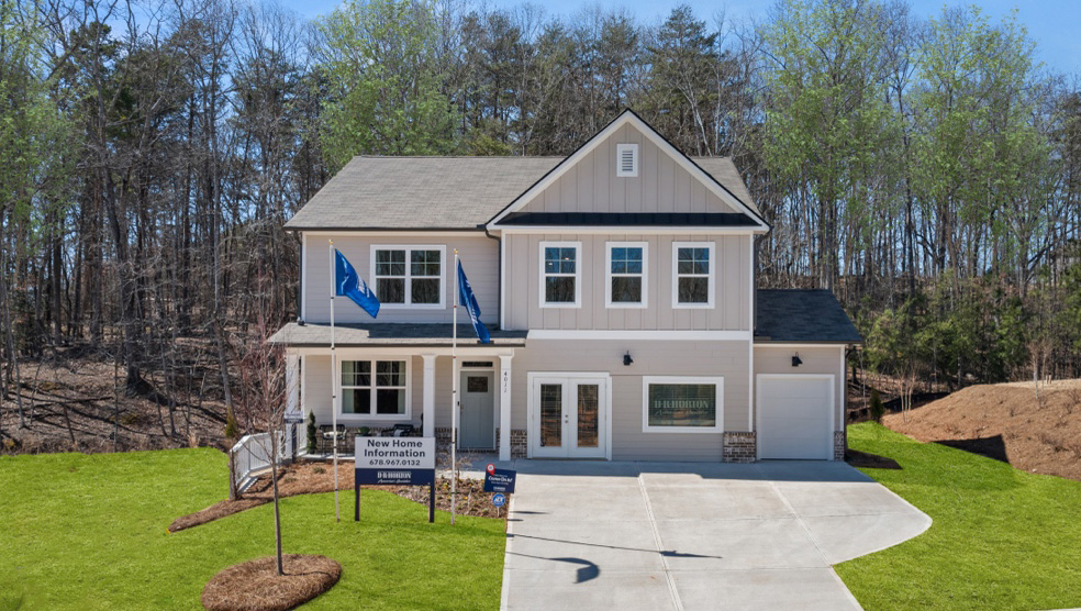 Exterior two-story home with cladding and stone detailing