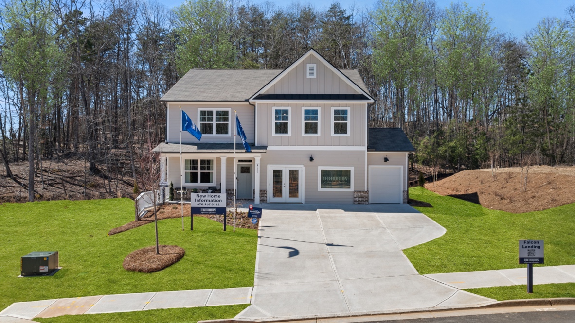 Exterior two-story home with cladding and stone detailing