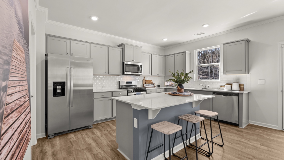 Interior kitchen with center island and light grey cabinets
