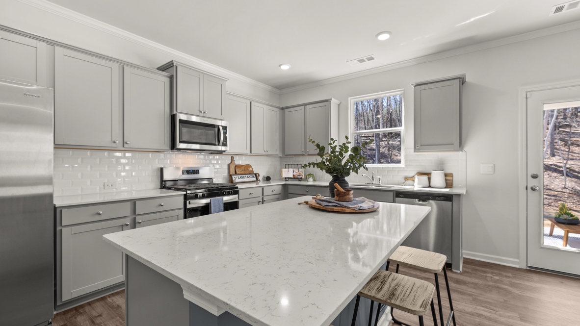 Interior kitchen with center island and light grey cabinets