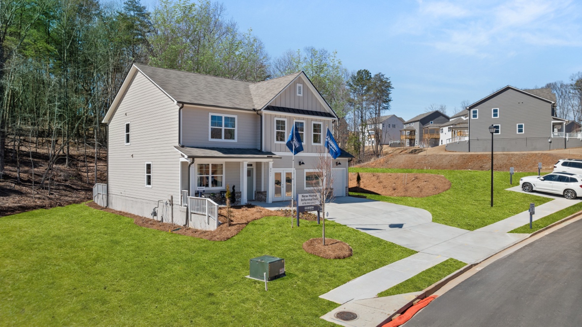 Exterior two-story home with cladding and stone detailing