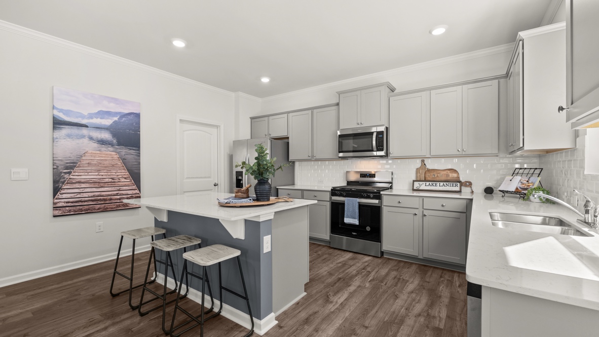 Interior kitchen with center island and light grey cabinets