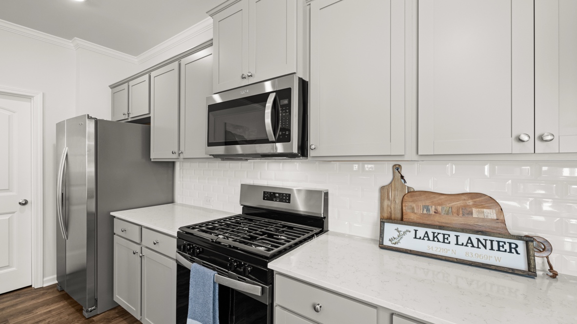 Interior kitchen with center island and light grey cabinets