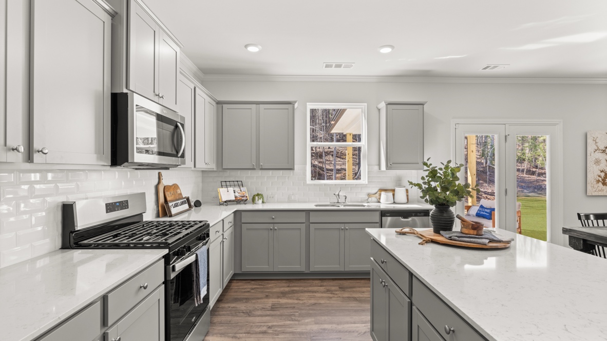 Interior kitchen with center island and light grey cabinets