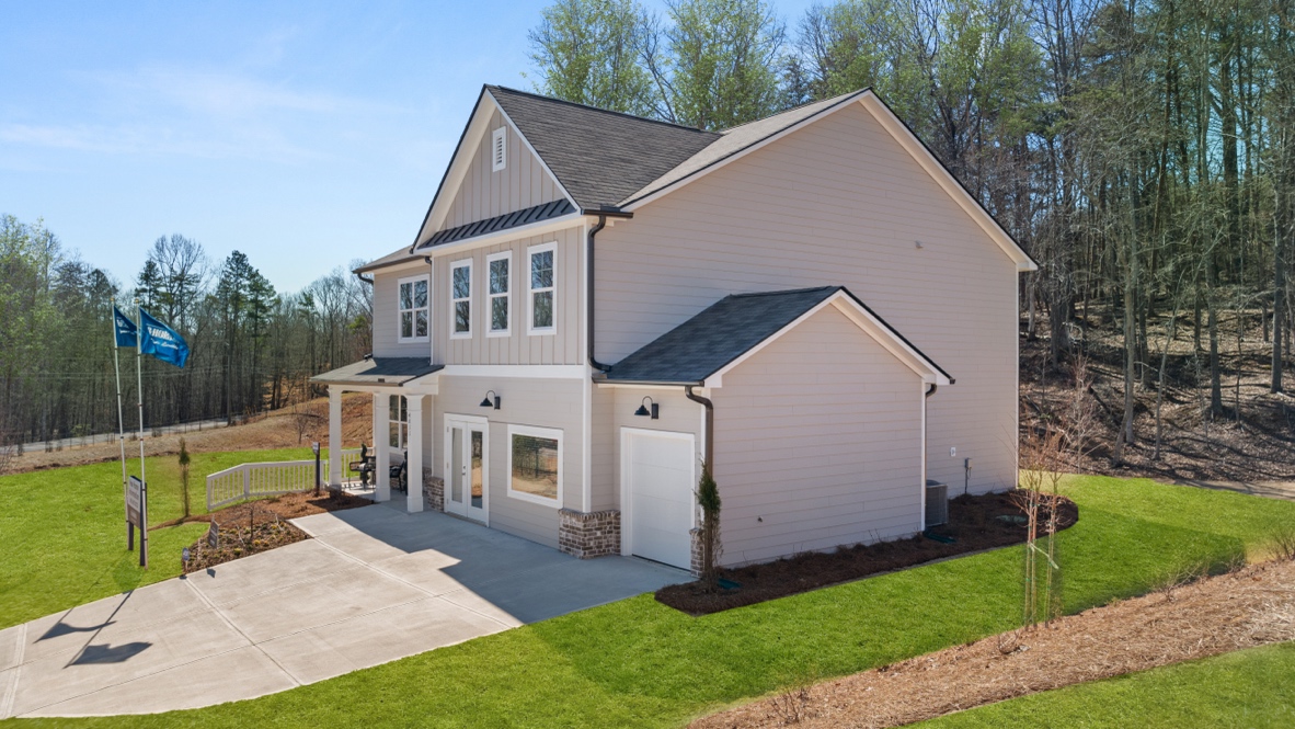 Exterior two-story home with cladding and stone detailing